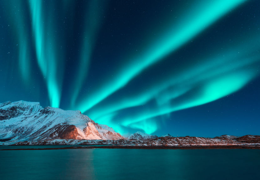 Aurora borealis above the snow covered mountain